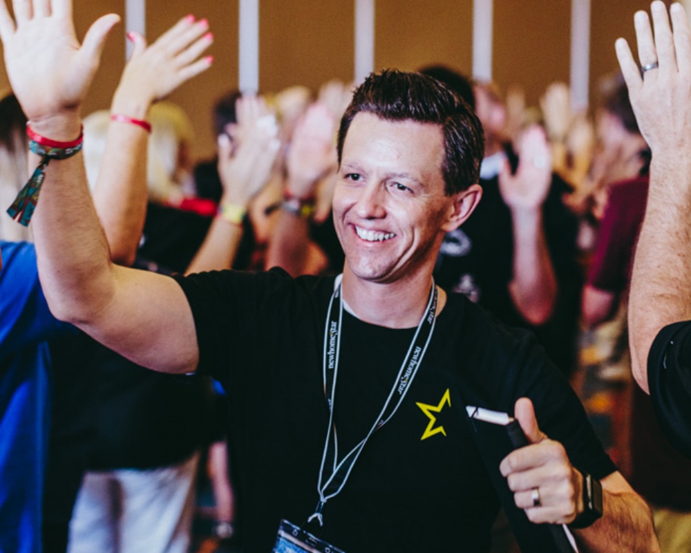 Employee Wearing Company Merchandise Waving